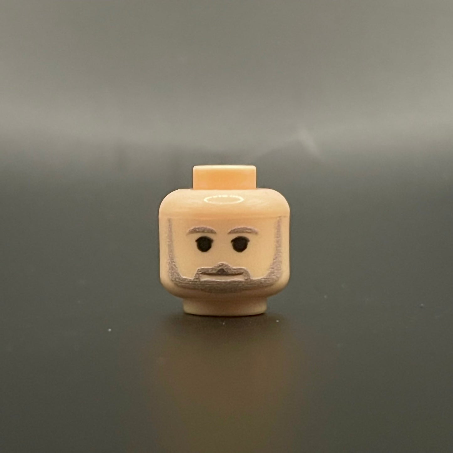 Classic George Head LEGO minifigure head with beard and neutral expression on gray background
