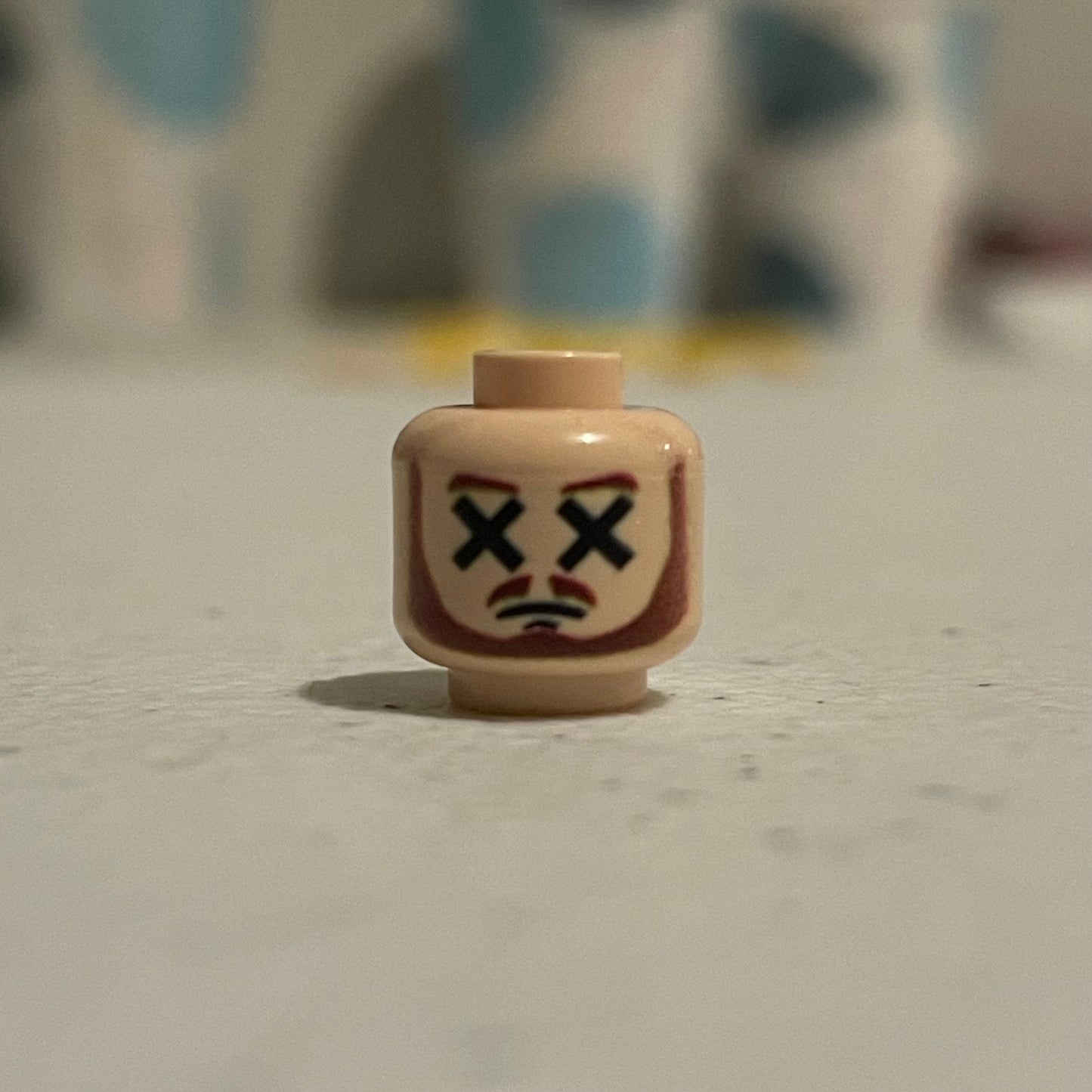 Classic Dead Master Head LEGO minifigure face with crossed-out eyes and frown expression