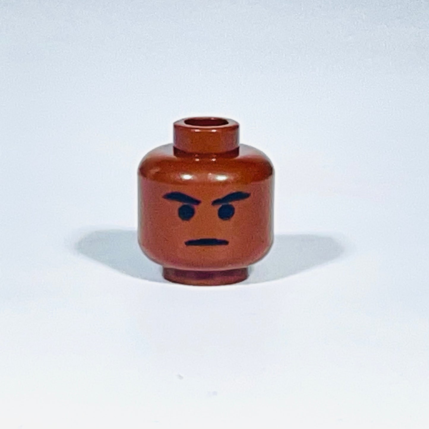Classic Mace Head LEGO minifigure head with angry facial expression in brown color isolated on white background