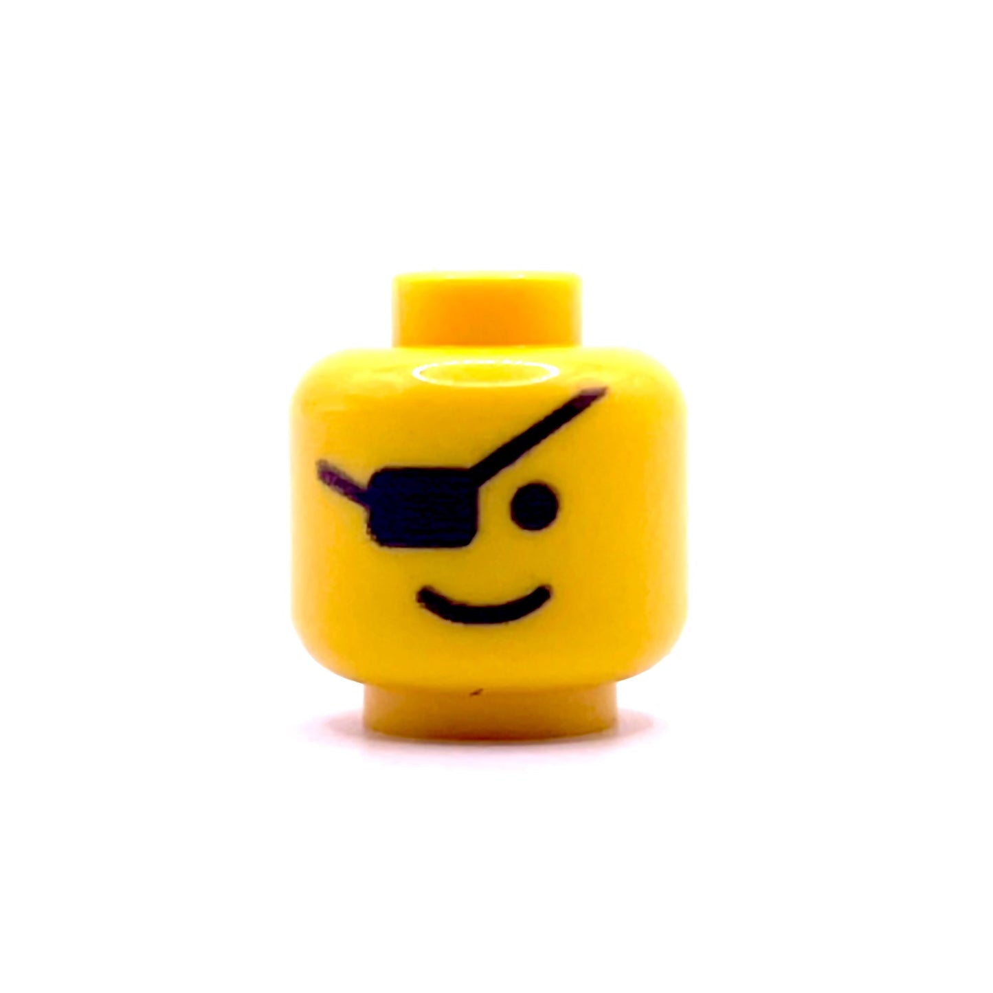 Yellow LEGO minifigure head with classic eyepatch and smile face design