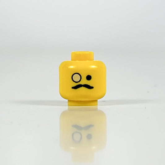 LEGO minifigure monocle head accessory close-up