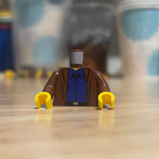 Arthur Torso LEGO minifigure torso with brown jacket and blue shirt on wooden surface