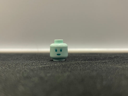Classic Hologram Leah Head LEGO minifigure face piece on black surface