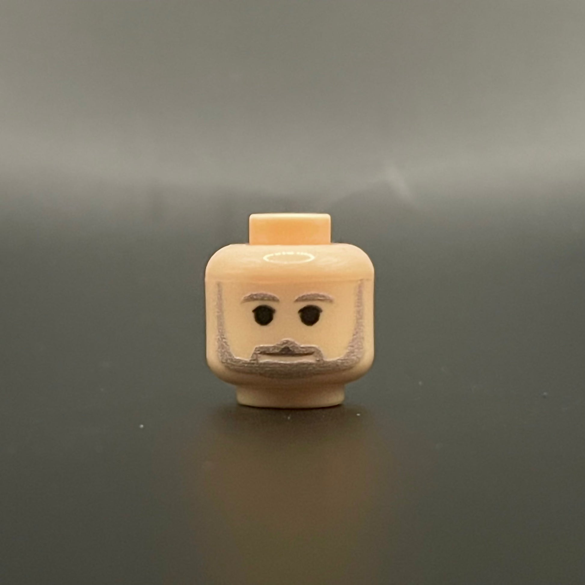 Classic George Head LEGO minifigure head with beard and neutral expression on gray background