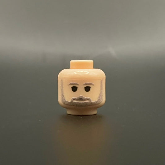Classic George Head LEGO minifigure head with beard and neutral expression on gray background