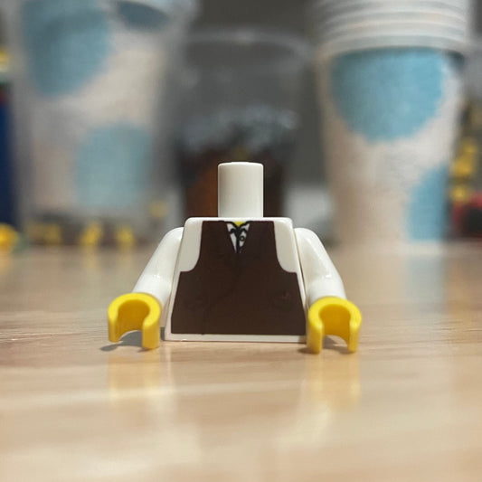 LEGO minifigure banker torso with white sleeves and brown vest on wooden surface