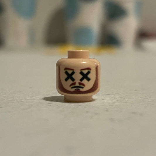 Classic Dead Master Head LEGO minifigure face with crossed-out eyes and frown expression