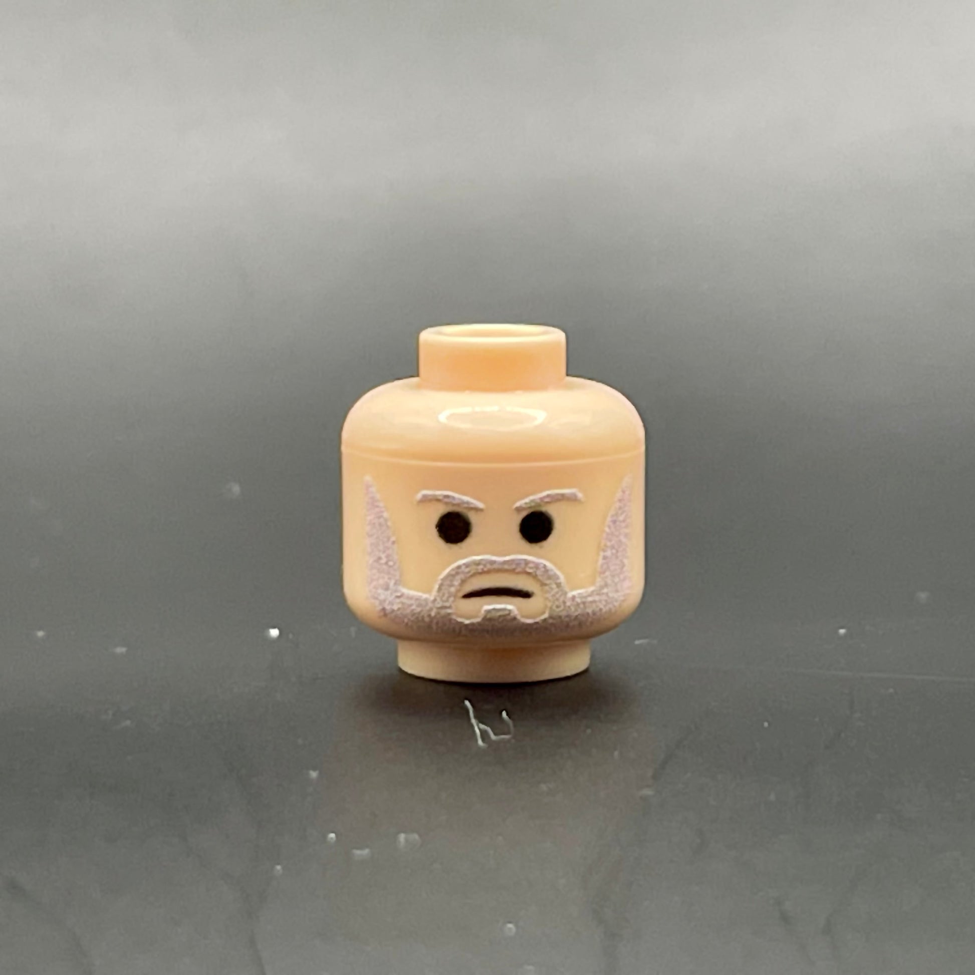 Classic Ben Head LEGO minifigure part with printed beard and eyebrows on a gray background